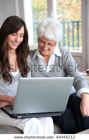 Young woman and elderly woman with laptop computer