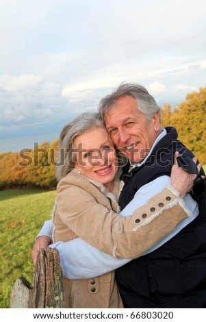 Happy senior couple embracing each other in countryside