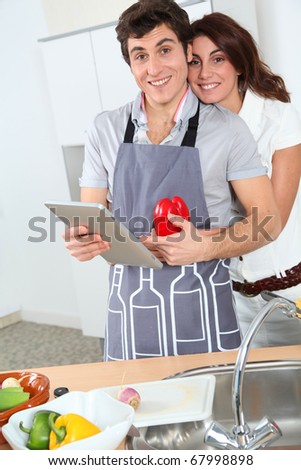 Couple cooking with electronic tab