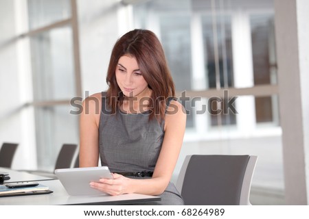 Beautiful businesswoman working on electronic tab
