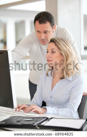 Office workers in front of desktop computer