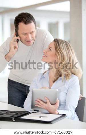Office workers using electronic tab in the office