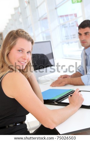 Woman in office signing contract