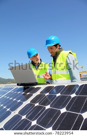 Engineers checking solar panel setup