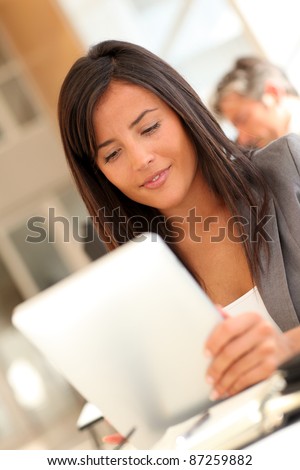 Beautiful businesswoman using electronic tablet