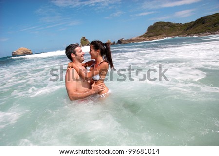 Cheerful couple swimming in the ocean