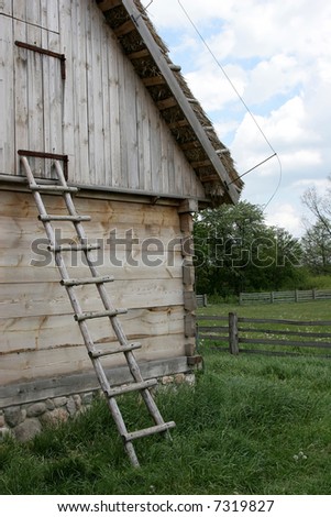 Old wooden ladder in front of historic barn