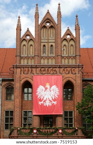 Torun City Hall with Polish flag before national celebration