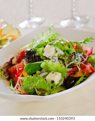 fresh vegetarian salad with olives and cheese