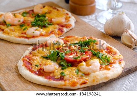 seafood mini pizza with parmesan cheese