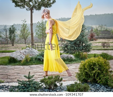 The girl in the park in a yellow dress