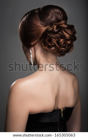 Woman in evening dress with beautiful hairstyle from the back