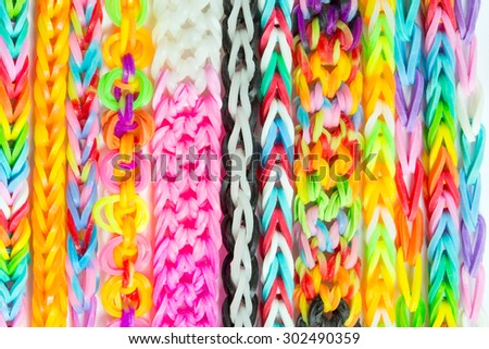 colorful Rainbow loom bracelet rubber bands fashion on old wood background.  - Stock Image - Everypixel
