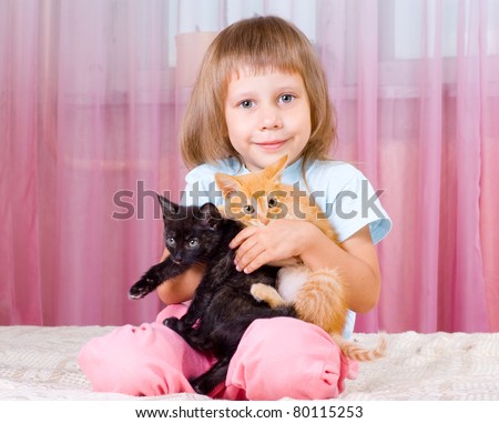 Girl hugging red and black kitten