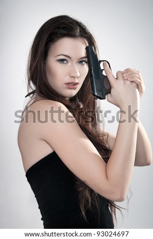 Girl aiming a gun, arms outstretched