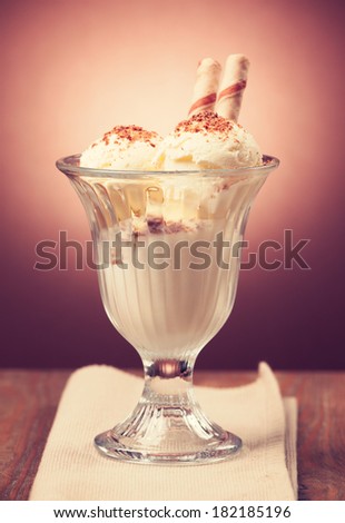 Ice cream in the glass on the table.Vintage retro hipster style version