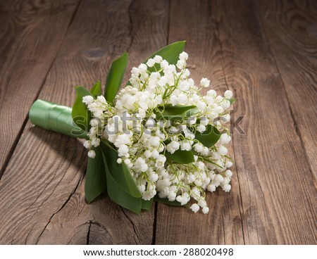 bouquet of lilies of the valley on the old board