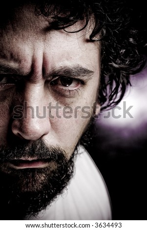 Portrait of man with beard staring into the camera grunge look