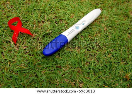 A pregnancy test and the red ribbon of Aids