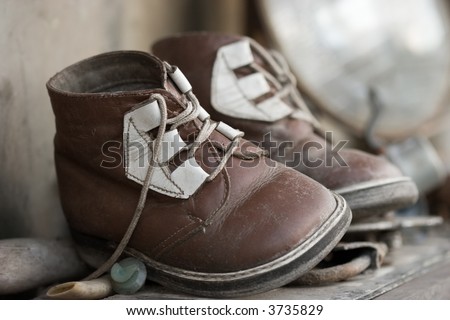 The pair of old baby shoes. Childhood or past time nostalgic concept.
