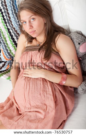 Pregnant woman laying on the sofa.