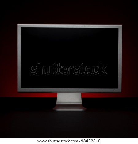Wide screen modern monitor on a black background.