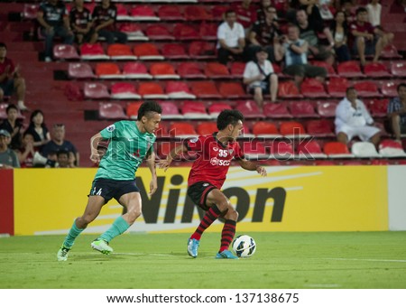 BANGKOK, THAILAND- MAY 1 : Weerawut Kayem (r) in action during AFC Champions League 2013 Between Muangthong Utd (R) Vs Urawa red Diamonds(G) on May 1, 2013 at SCG Stadium, Bangkok, Thailand