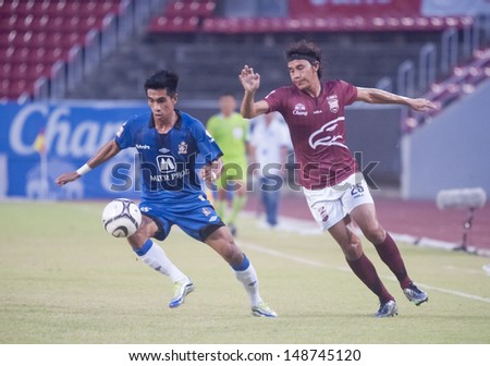 PATHUMTHANI,THAILAND JUNE 26 : Adul Meunsaman (R) in action during Thai Premier League 2013 between Insee Police (R) and Ratchaburi FC (B) at Thammasat Stadium on June 26,2013 in Thailand