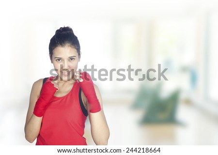 Young beautiful woman 20 - 30 year old during fitness time and exercising in gym.Mixed Asian / Caucasian