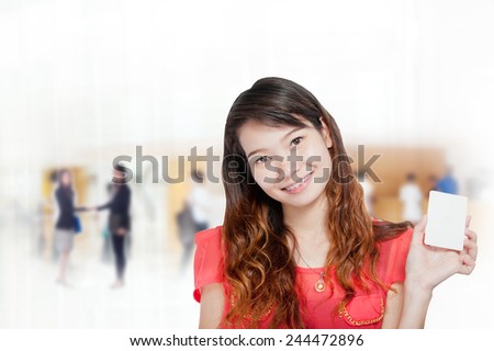 Portrait of young asia business woman 20-30 year old hold card in her office.Mixed Asian / Caucasian businesswoman.Positive emotion