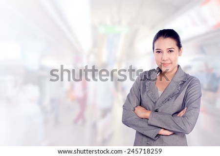 portrait asian businesswoman 20 - 30 year old with long hair has shopping mall background.Mixed Asian / Caucasian businesswoman.Positive emotion