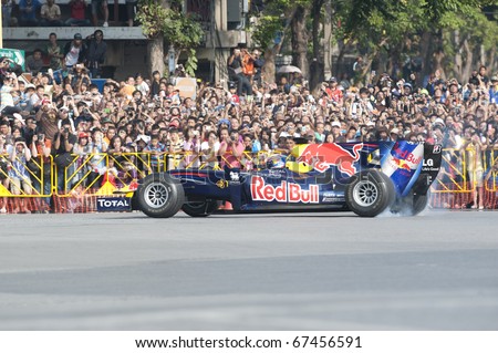 BANGKOK,THAILAND - DECEMBER 18: Mark Webber of Red Bull Racing Team speeding show on Street of Kings, Ratchadamnoen Red Bull Bangkok 2010 ,December 18, 2010 in Bangkok,Thailand