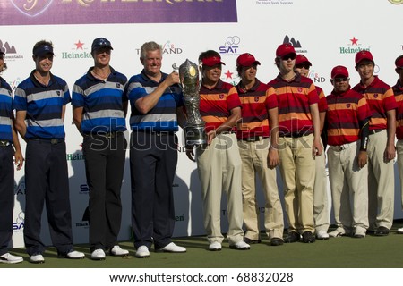 HUA HIN, THAILAND - JANUARY 9: Members of the Europea&Asia team lifting the trophy after winning the Royal Trophy tournament at Black Mountain Golf Club Hua Hin Thailand on January 9, 2011.