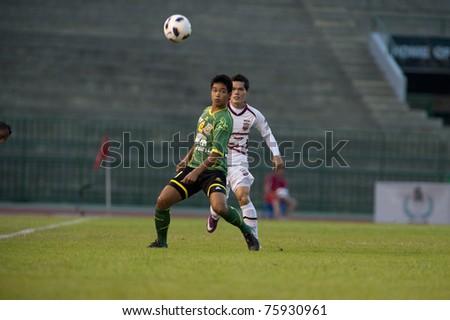 BANGKOK THAILAND- APRIL 24: D.Dinket (green) in action during Thai Premier League (TPL) between Army Utd. (green) vs Insee Police Utd. (white) on April 24, 2011 at Army Stadium in Bangkok Thailand