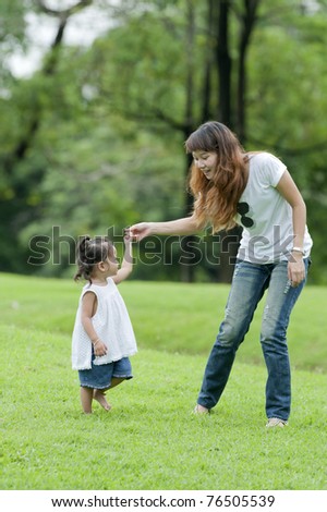 Mother teaching daughter learned a little walk in the park.