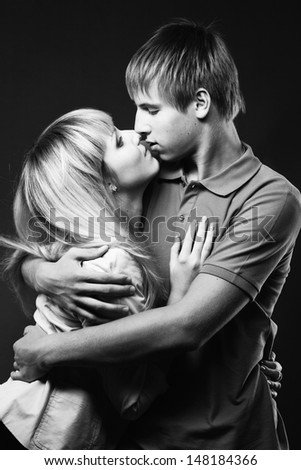 Young beautiful couple against white background