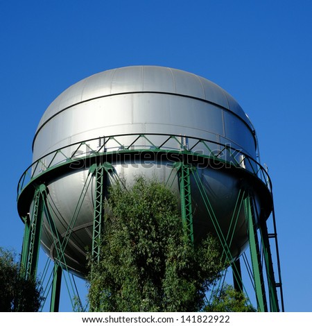 A large water tower in a residential neighborhood serves the local community