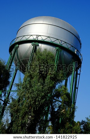 A large water tower in a residential neighborhood serves the local community