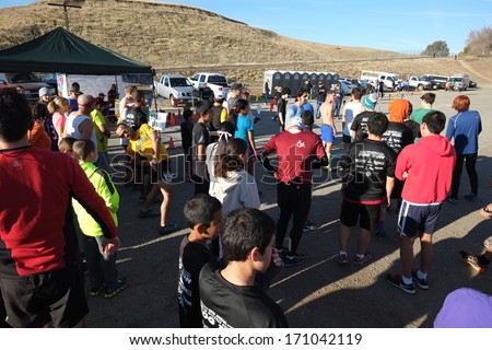 BAKERSFIELD, CA - JAN 11, 2014: More than 800 runners, joggers, walkers, dogs, and mothers with baby strollers talk before the start of the Annual Fog Run, in good weather this year.