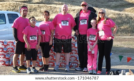 BAKERSFIELD, CA - JAN 11, 2014: Runners sponsored by the Lamont Sheriff's station span all age groups for the Annual Fog Run. They wear pink breast cancer awareness T-shirts.