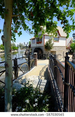 A replica mill house is a feature of an urban renewal and city beautification project along a canal in Central California