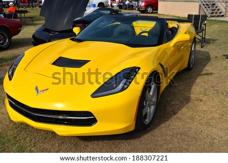 BAKERSFIELD, CA-APRIL 19, 2014: An almost new yellow 2014 Chevrolet Corvette with only 500 miles on the road is entered in the Cruisin\' For A Wish Car & Motorcycle Show.