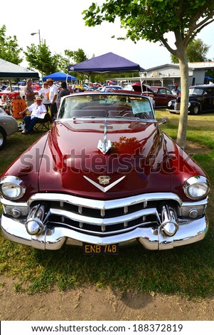 BAKERSFIELD, CA-APRIL 19, 2014: A very pretty maroon 1953 Cadillac convertible vies for attention among all the cars at the Cruisin\' For A Wish Car & Motorcycle Show.