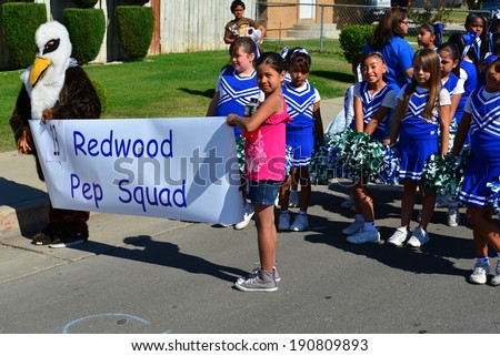 SHAFTER, CA - MAY 3, 2014: These little girls, members of the Redwood School's pep squad,  are on their way to march in the Cinco de Mayo Celebration parade.