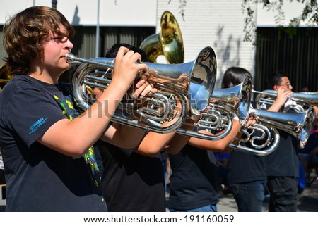 SHAFTER, CA - MAY 3, 2014: The Shafter High School band brass section plays with enthusiasm on a hot day during the Cinco de Mayo Celebration parade.