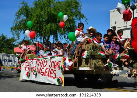 SHAFTER, CA - MAY 3, 2014: The children of the Head Start program ride on a float on a hot day during the Cinco de Mayo Celebration parade.