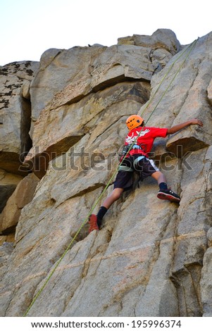 KERN COUNTY, CA-MAY 31, 2014: Nick Olsen is one of several teenage students from Olive Knolls Christian School who are building confidence by getting climbing instruction today.