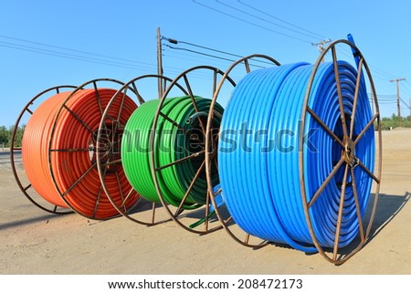SHAFTER, CA-AUGUST 1, 2014: Colorful reels of new plastic conduit are on a construction job site, ready for direct burial in a trench for a city project.