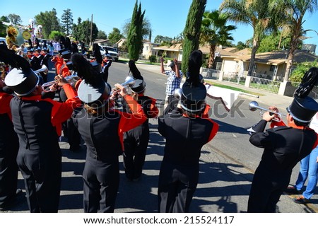 WASCO, CA - SEPTEMBER 6, 2014: Band director Greg Sparks (blue shirt) tunes up the Wasco Union High School musicians before the start of the Festival of Roses parade.