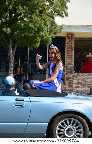 WASCO, CA-SEPTEMBER 6, 2014: Morgan Campbell was last year's Rose Queen. She takes her final ride in the annual Festival of Roses parade prior to relinquishing her crown to this year's royalty.